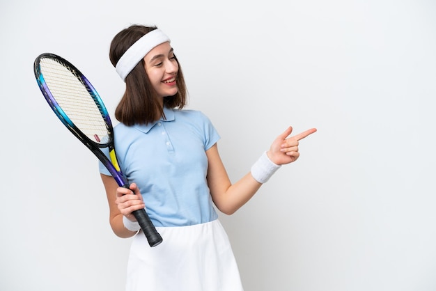 Giovane tennista ucraino donna isolata su sfondo bianco che punta il dito di lato e presenta un prodotto