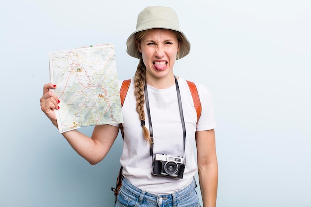 Giovane turista donna bionda adulta con un concetto di vacanze mappa