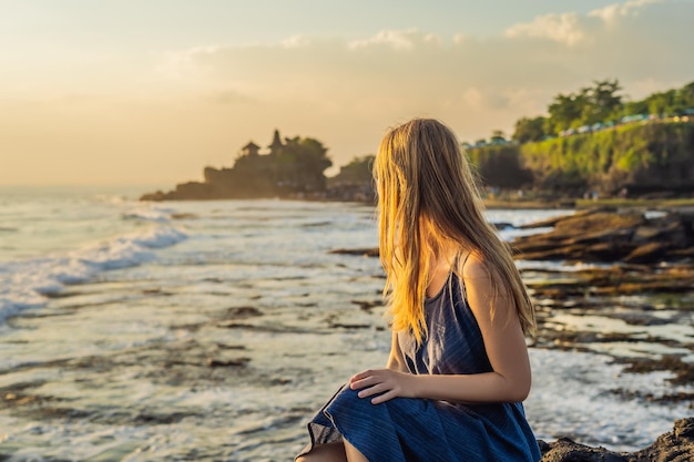 Giovane turista sullo sfondo di Tanah Lot - Tempio nell'Oceano. Bali, Indonesia