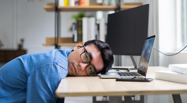 Giovane uomo asiatico che lavora in ufficio