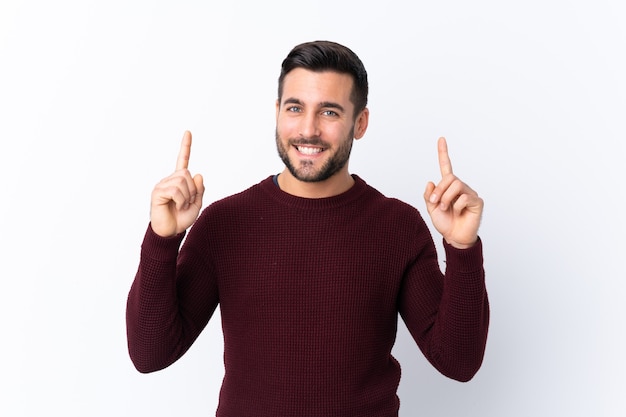 Giovane uomo bello con la barba isolata che indica una grande idea