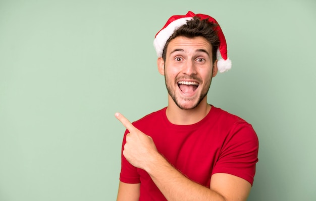 Giovane uomo bello con un concetto di natale del cappello della Santa