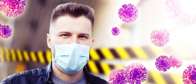 Giovane uomo in maschera facciale sterile contro il virus corona.