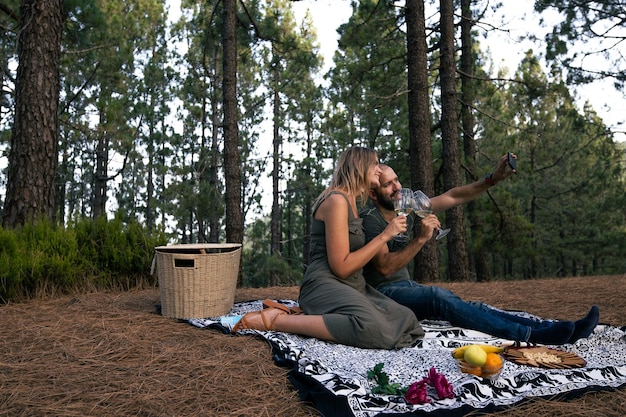 Giovani coppie che prendono una foto insieme su un picnic