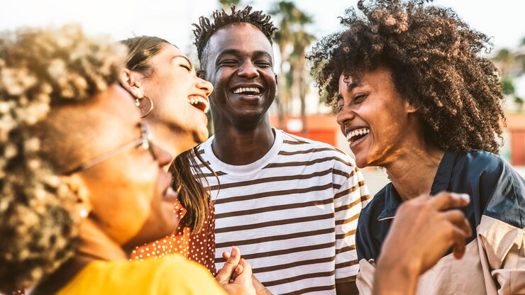 Giovani felici che ridono insieme - Gruppo di amici multirazziali che si divertono sulla strada della città - Ritratto di studenti di cultura diversa che celebrano fuori - Amicizia, comunità, gioventù, concetto universitario.
