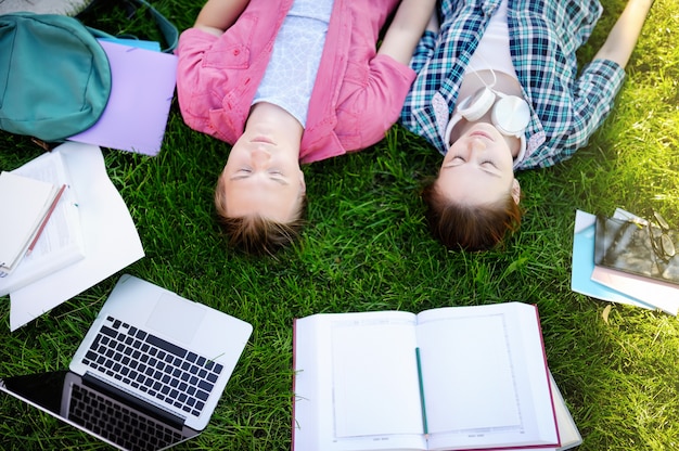 Giovani studenti felici con libri e note all&#39;aperto