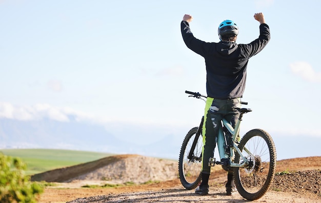 Gli sport ciclistici e l'uomo festeggiano in bicicletta per aver vinto l'avventura, la libertà e il successo.
