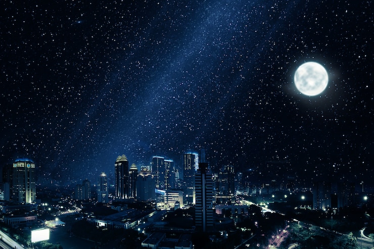 Photo glowing city with bright moon and many stars in sky