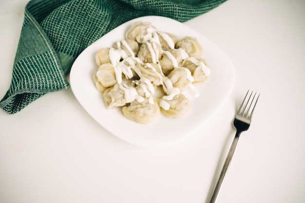 Gnocchi di carne di pelmeni russi con burro e yogurt.