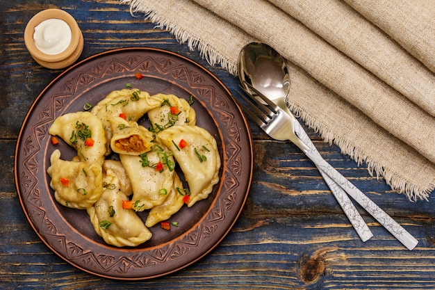 Gnocchi ripieni di cavolo stufato e panna acida. Piatto ucraino tradizionale varenyky