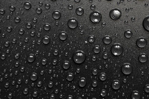 Gocce d'acqua su sfondo nero Gocce di texture foto macro