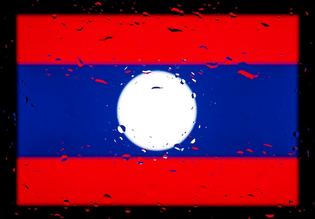 Gocce d'acqua sullo sfondo della bandiera del Laos Profondità di campo ridotta Messa a fuoco selettiva Tonica