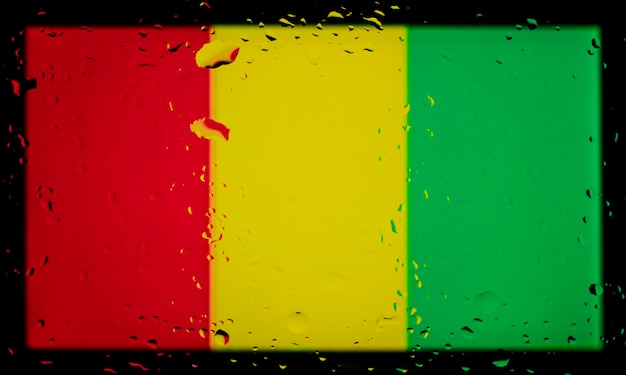 Gocce d'acqua sullo sfondo della bandiera della Guinea Profondità di campo ridotta Messa a fuoco selettiva Tonica