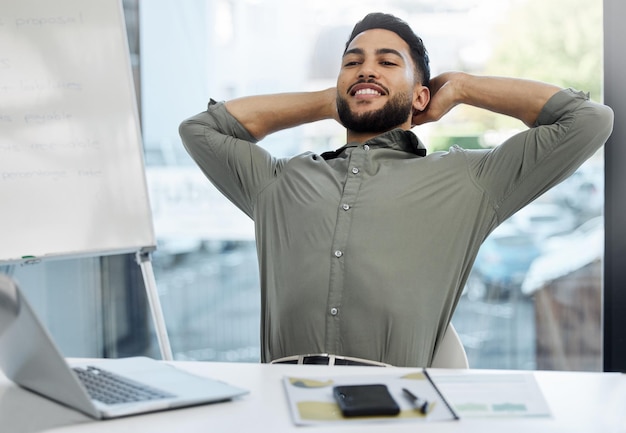 Godendo i frutti del mio duro lavoro Inquadratura di un giovane uomo d'affari che si prende una pausa in un ufficio al lavoro