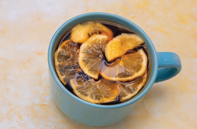 grande tazza blu con tè e una fetta di limone