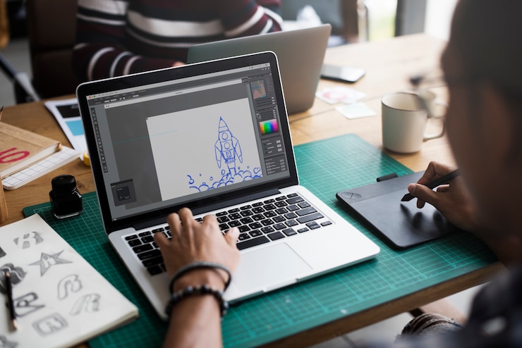Photo graphic designer working with laptop and mousepad