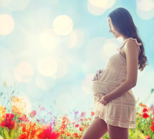 gravidanza, maternità, persone e concetto di aspettativa - felice donna incinta in chemise su sfondo blu con fiori