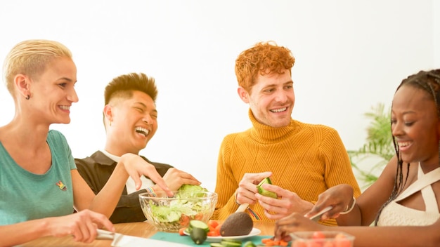 Gruppo di amici che preparano un'insalata a casa