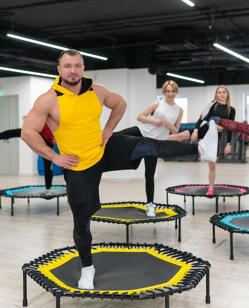 Gruppo di donne e uomini su un trampolino sportivo allenamento fitness vita sana un trampolino di concetto