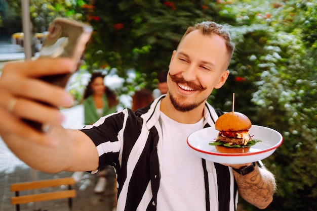 Gruppo di giovani amici che si incontrano in un bar a mangiare hamburger freschi e gustosi Fast food Persone