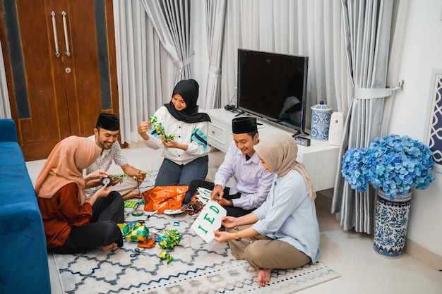 Gruppo di giovani musulmani che fanno e preparano decorazioni Eid