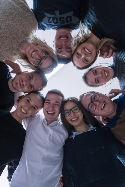 Gruppo di giovani studenti in aula di elettronica che celebrano con successo il progetto finito tenendo le mani insieme, concetto di istruzione e tecnologia