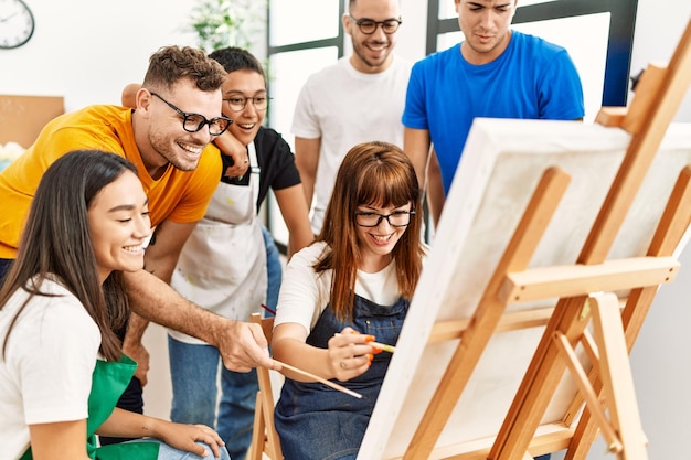 Gruppo di persone che sorridono felici e che guardano pareggio del partner allo studio d'arte