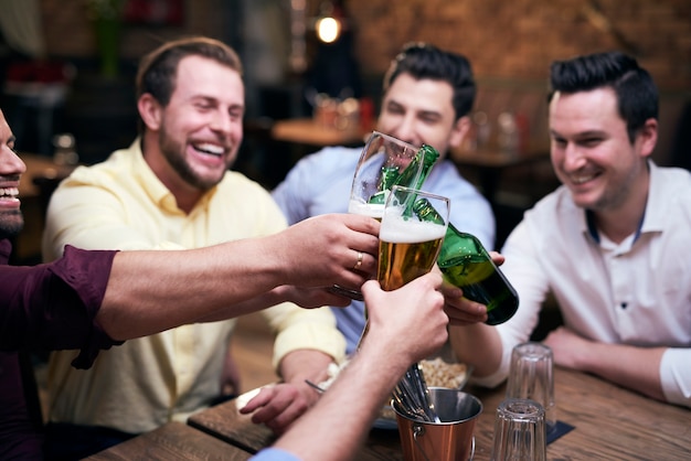 Gruppo di uomini che fanno un applauso al bar