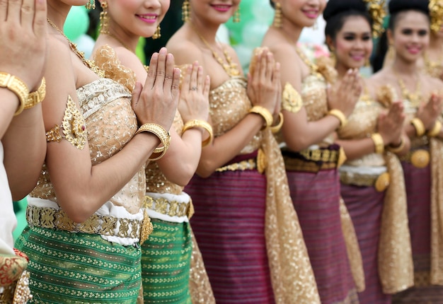 Gruppo non identificato di ballerini tailandesi che sorridono e pagano il rispetto