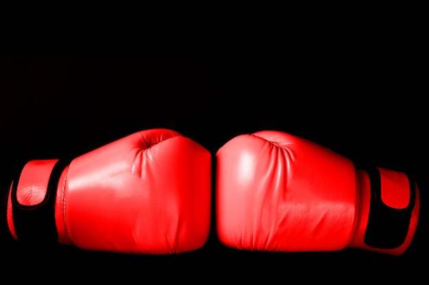 Guanto da boxe rosa nella punzonatura su sfondo nero nel concetto di donna