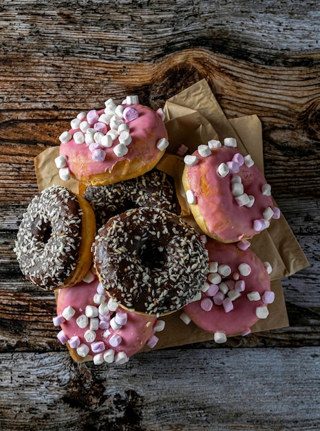 Gustose ciambelle glassate e cocolate al forno isolate su una tavola di legno Marrone rosa Atmosfera calda