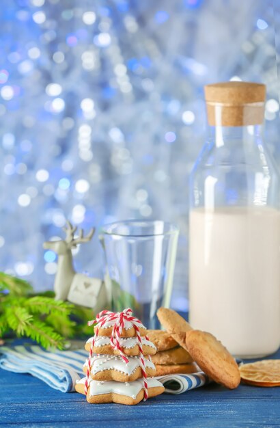 Gustosi biscotti natalizi fatti in casa e bottiglia con latte sul tavolo