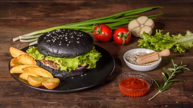 Gustoso hamburger alla griglia fatto in casa. Hamburger alla griglia deliziosi. Mestiere l'hamburger e le patate fritte del manzo sulla tavola di legno