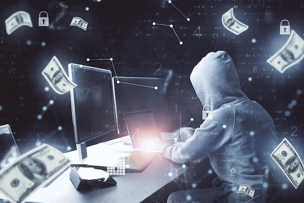 Hacker che usa il computer e banconote che cadono