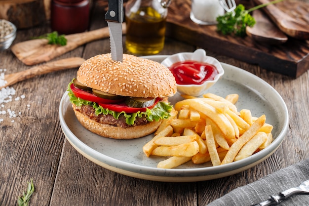 Hamburger americano classico con patatine fritte e ketchup