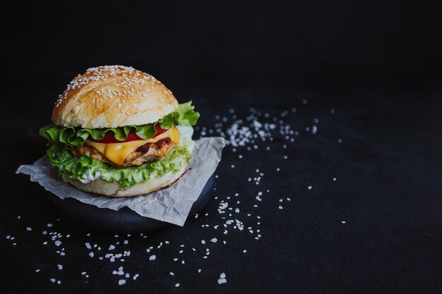 Hamburger appetitoso, con cotoletta di pollo, lattuga, pomodori, formaggio e salsa