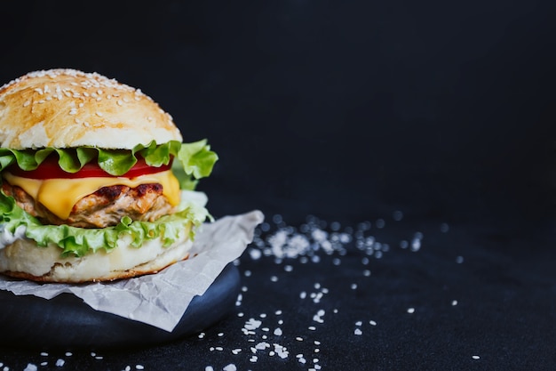 Hamburger appetitoso, con cotoletta di pollo, lattuga, pomodori, formaggio e salsa