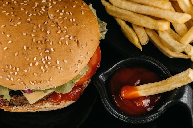 Hamburger con salsa e patatine fritte fresco gustoso hamburger