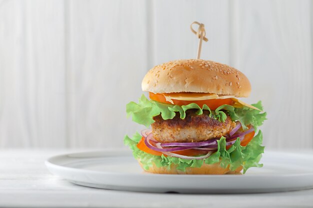 Hamburger di polpette con pomodori, formaggio e cipolle su un piatto