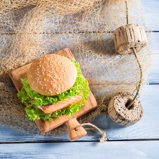 Hamburger fatto in casa con pesce e verdure su rete da pesca