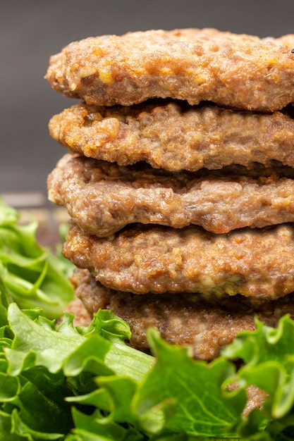 Hamburger fritti in pila con insalata verde