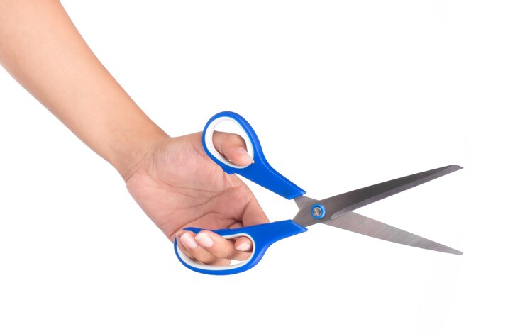 Photo hand holding blue scissors isolated on white background