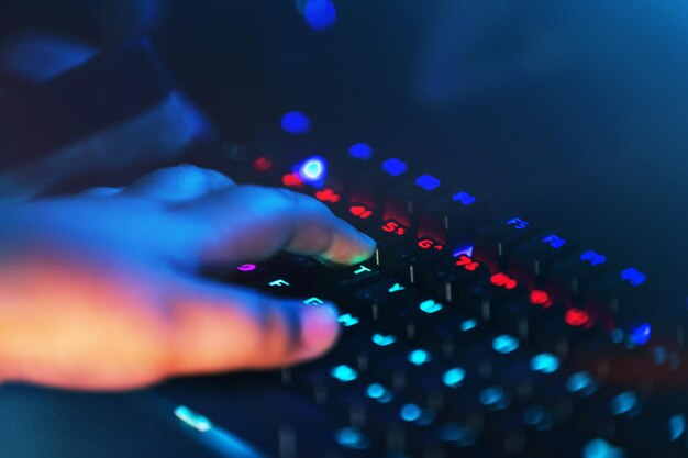Hand of a person working on a computer  close up of a keyboard computer with hand