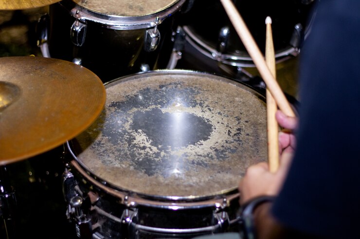 Hands of drummer with sticks and drums close-up