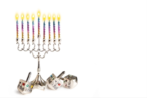 Hanukkah, tradizionale filatura dreidel, caramelle colorate su sfondo bianco. festa ebraica. bandiera. Spazio per il testo