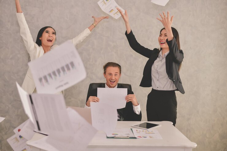 Photo happy business people throwing documents in office