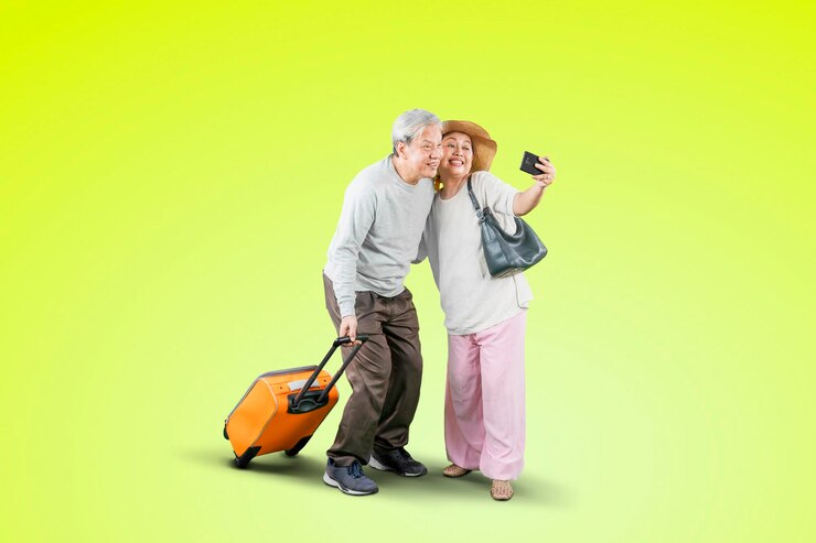 Happy old couple take selfie while carry luggage