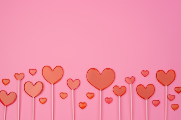 heart lollipops on a pink background