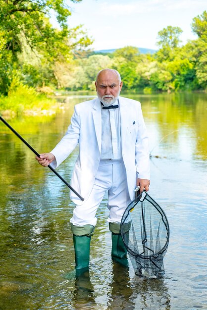 Hobby di pesca e weekend estivo Ritratto di uomo d'affari senior pesca uomo maturo pescatore in briciolo