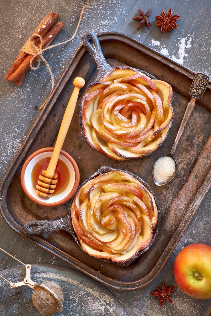 Homemade puff pastry with rose shaped apple slices baked in iron skillet